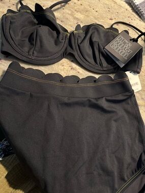 It's now Cool/free people black Scallop bikini. Top is a S. Bottom is XS.